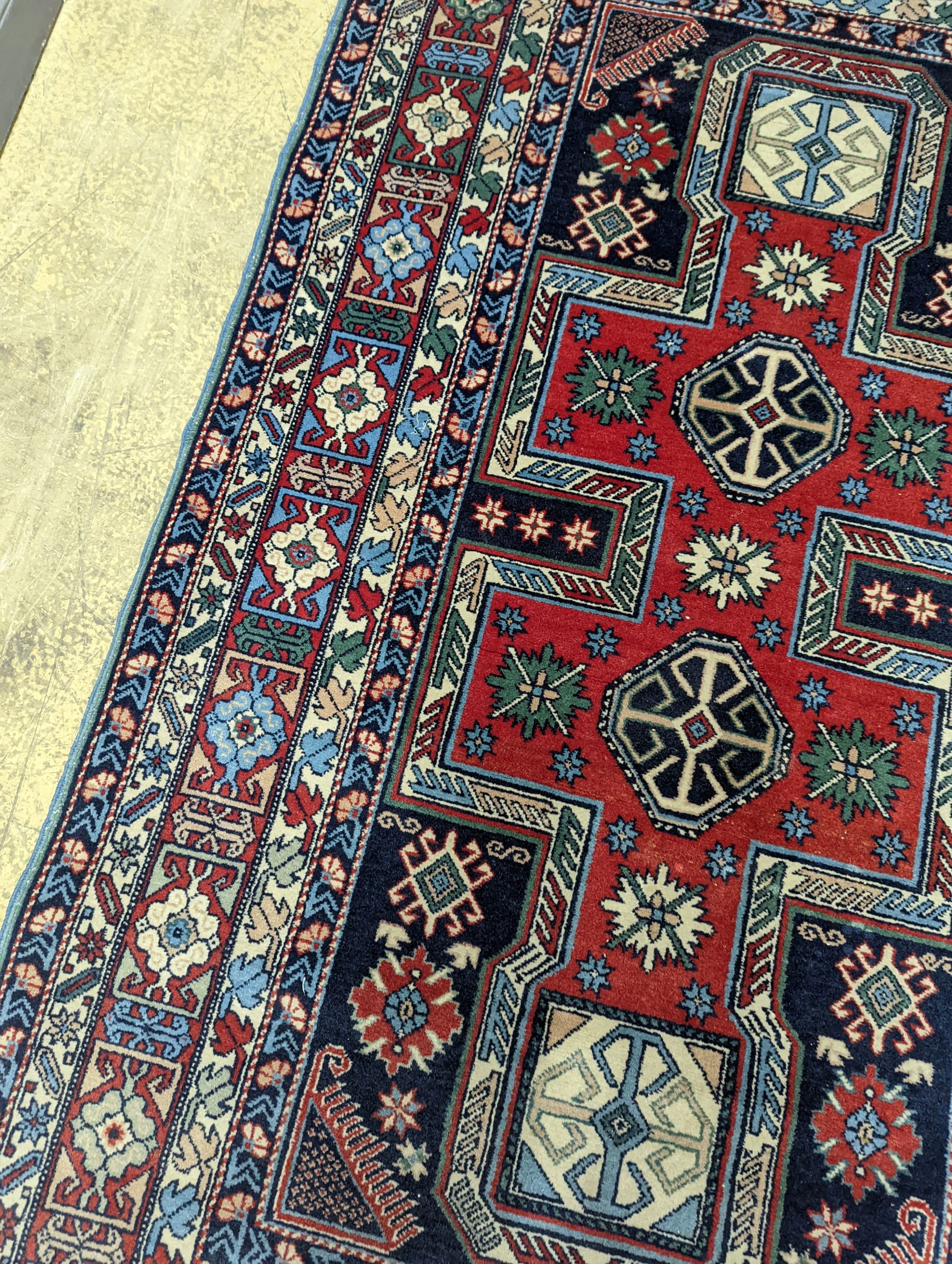 A Caucasian blue ground rug, 166 x 100cm